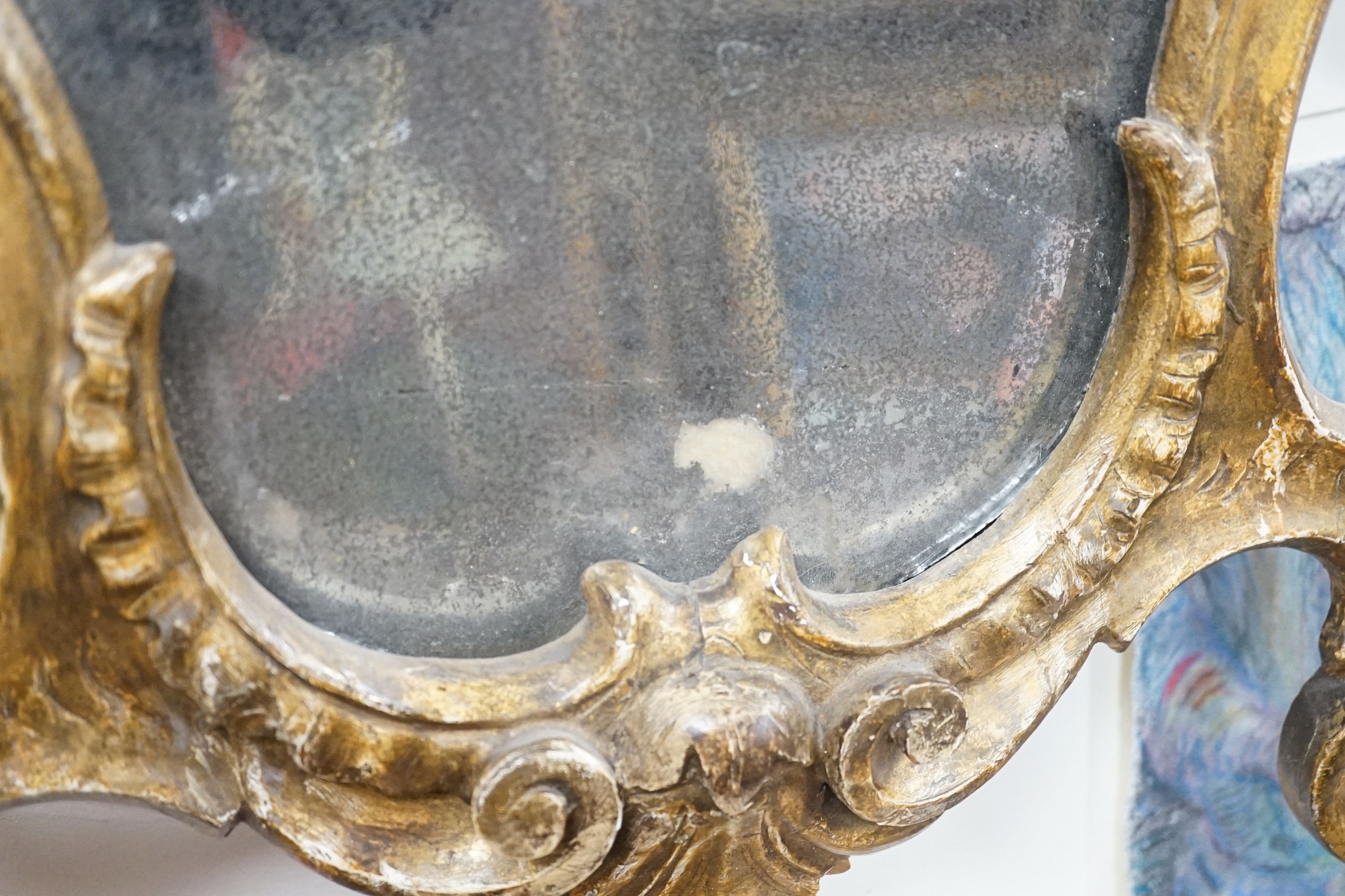 An 18th century Italian carved giltwood cartouche wall mirror, width 53cm, height 76cm